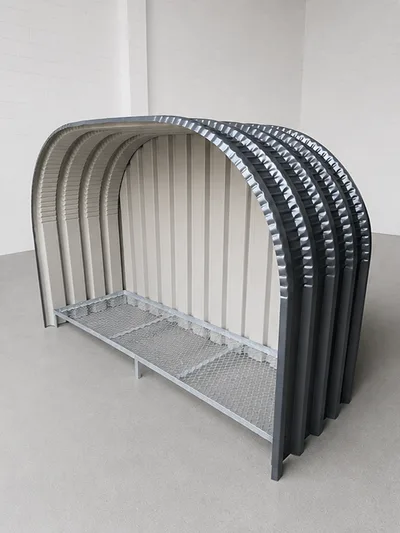 Firewood shed with a solid steel backing panel fixed across the rear, closing off the back of the stack