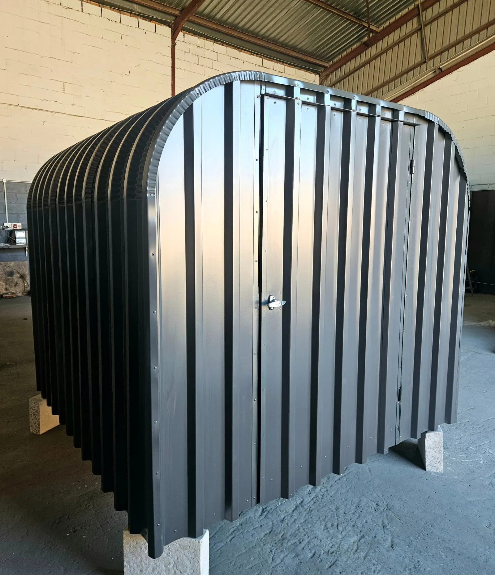 Side elevation of the charcoal bike shed with lockable door and arched roof profile