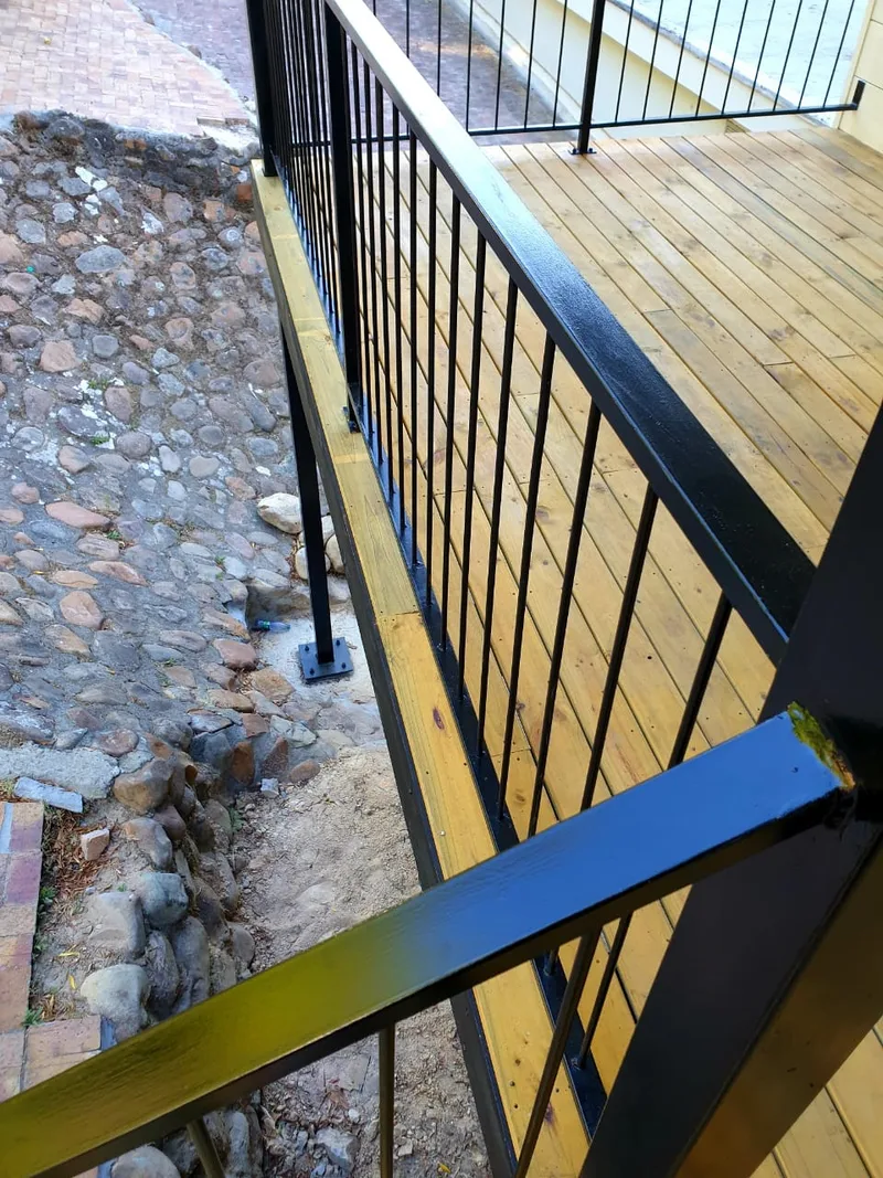 Steel balustrade detail at the edge of the raised timber deck